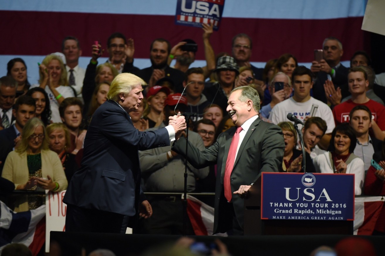 US President-elect Donald Trump shakes hands with Australian businessman Andrew Liveris during the USA Thank You Tour in Grand Rapids, Michigan.