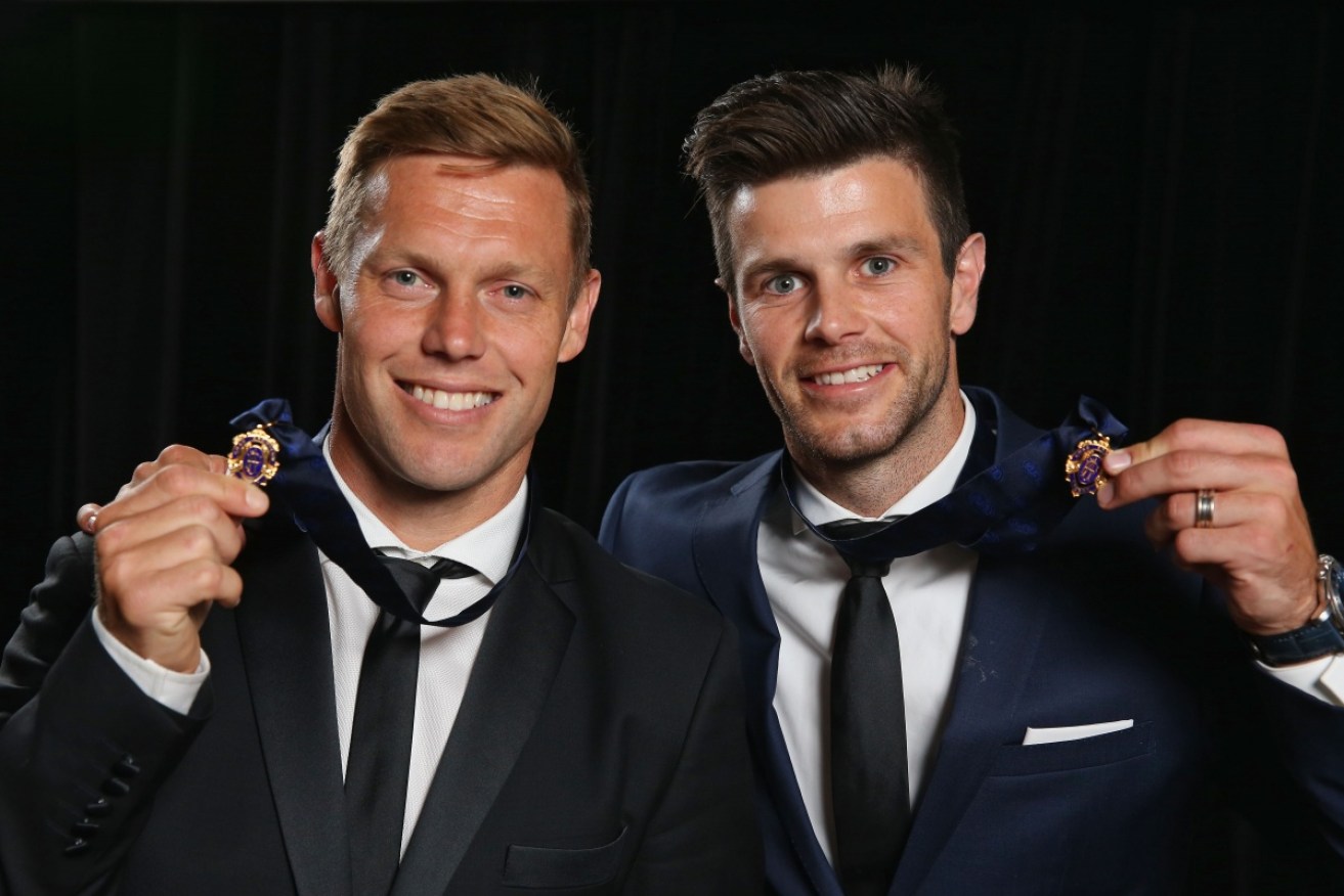 Sam Mitchell and Trent Cotchin celebrate with their 2012 Brownlow Medals.