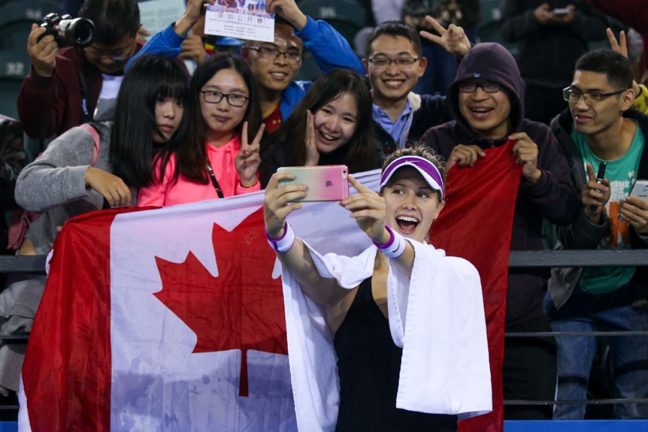 Eugenie Bouchard takes a photo with fans in China.