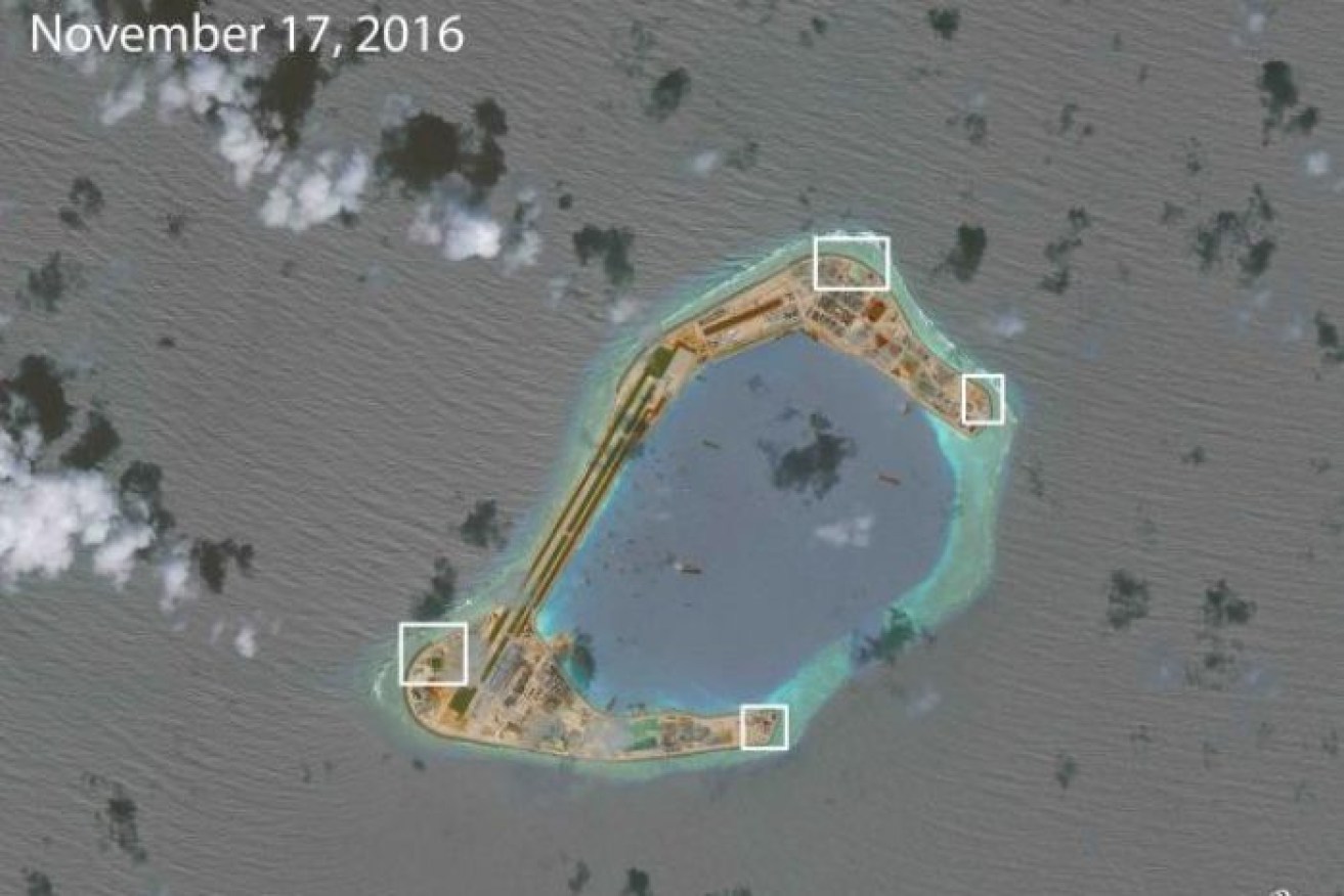 A satellite image of Subi Reef which the think tank says appears to show anti-aircraft guns and a weapons system.
