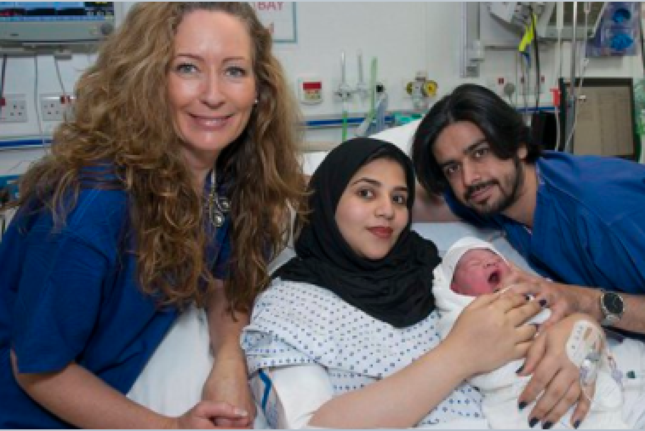 Moaza Al Matrooshi (centre) with husband Ahmed gave birth after having her ovary frozen aged nine.