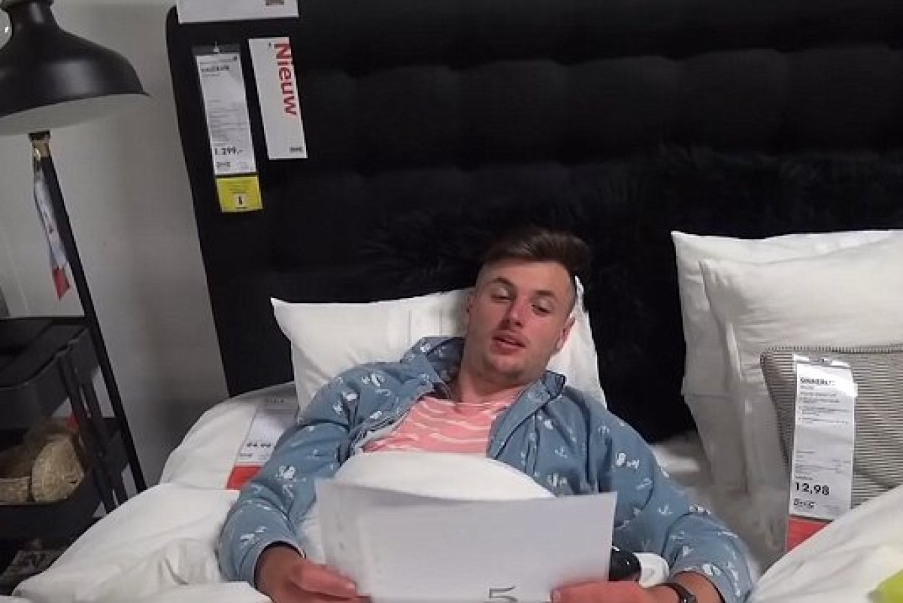 A Belgian participant tries out an IKEA bed in the middle of the night. 