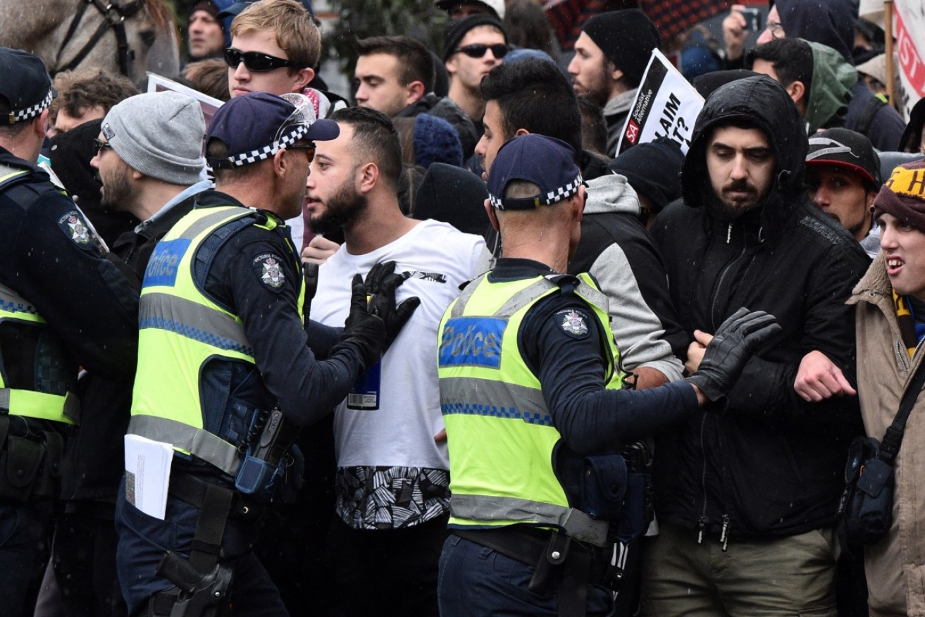 Police hold anti-immigration and anti-racism protesters apart as the two groups clash in Coburg in Melbourne in May.