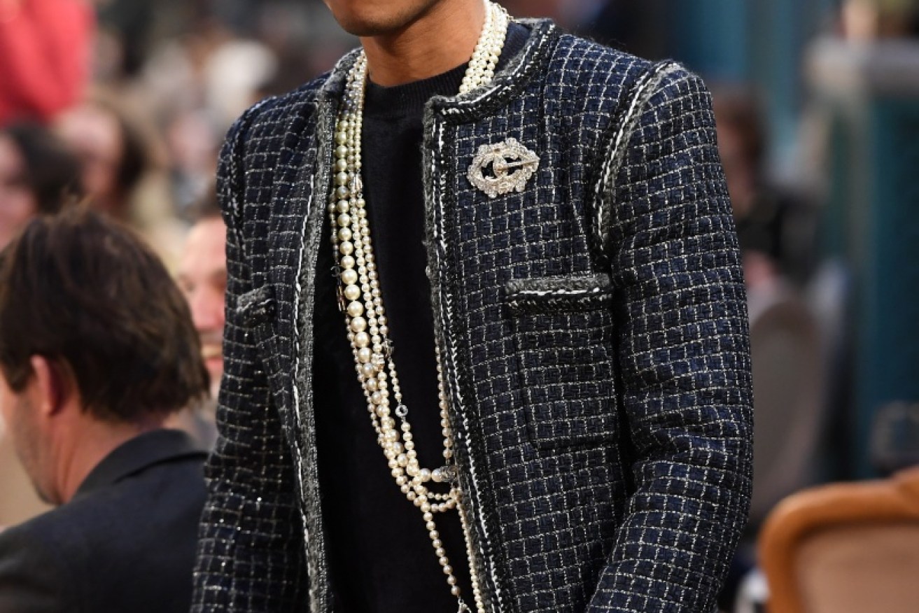Pharrell wore pearl necklaces to the Chanel show in Paris.