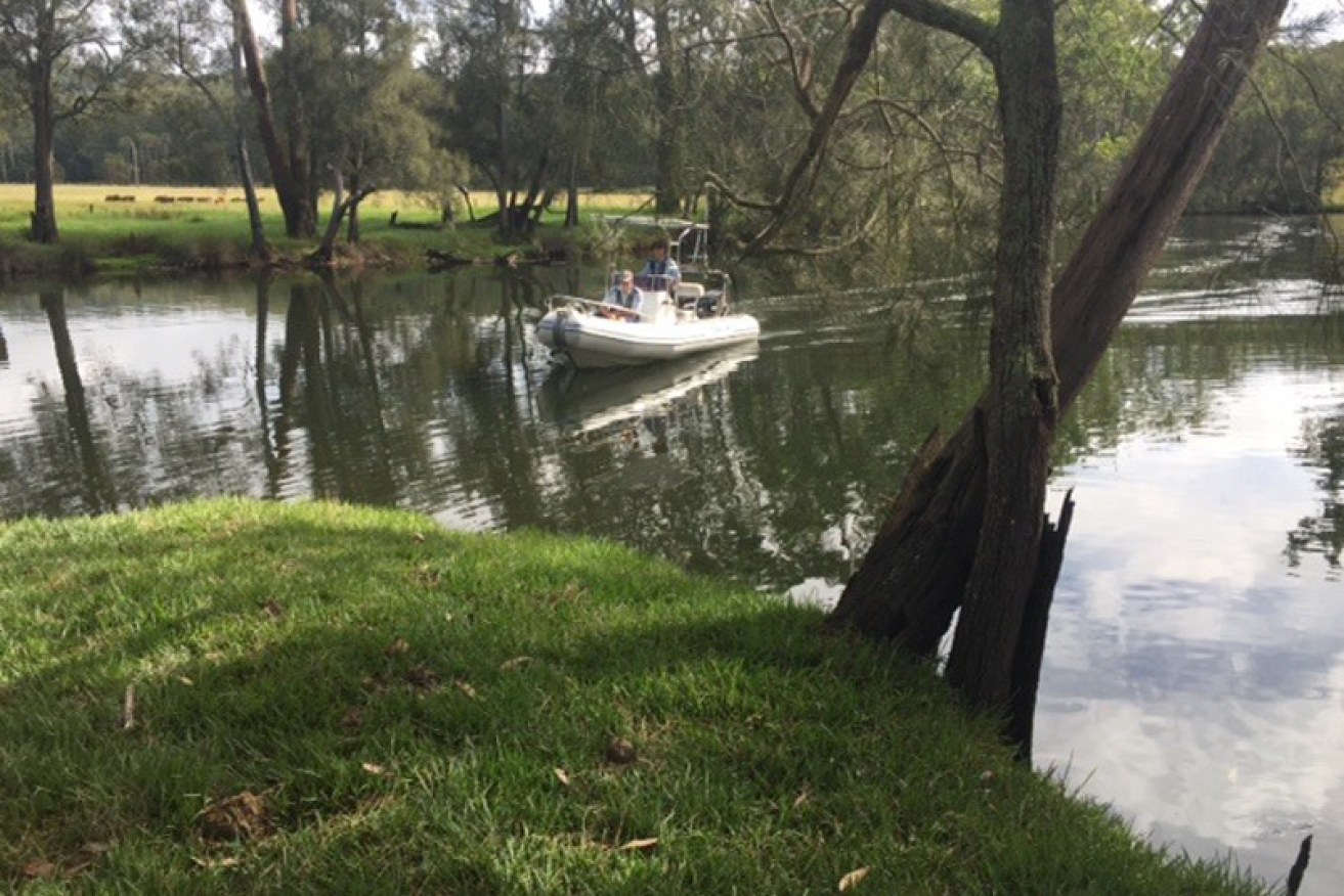 NSW Police officers searching for the body of a man who drowned while fishing in Bewong Creek, south of Nowra.