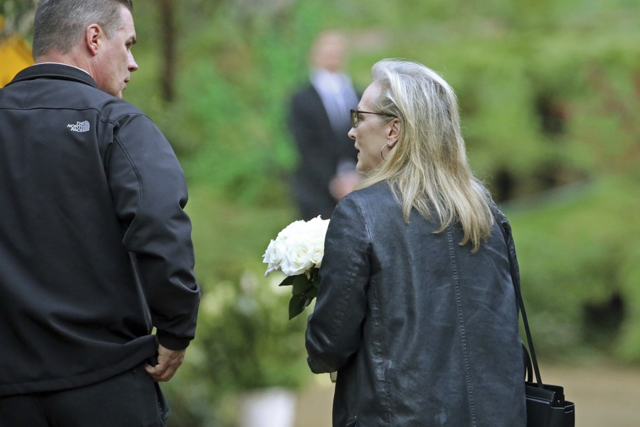 Actress Meryl Streep arrives with flowers at a memorial service for Debbie Reynolds and her daughter Carrie Fisher in Los Angeles.