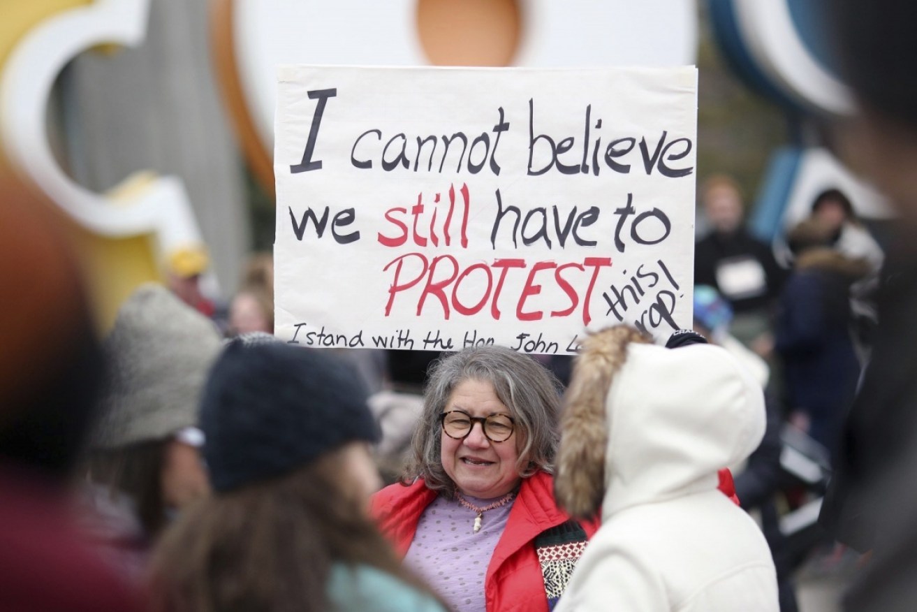 Diana Angus holds a home-made sign ahead of the Washington march, used when she rallied in Ohio.