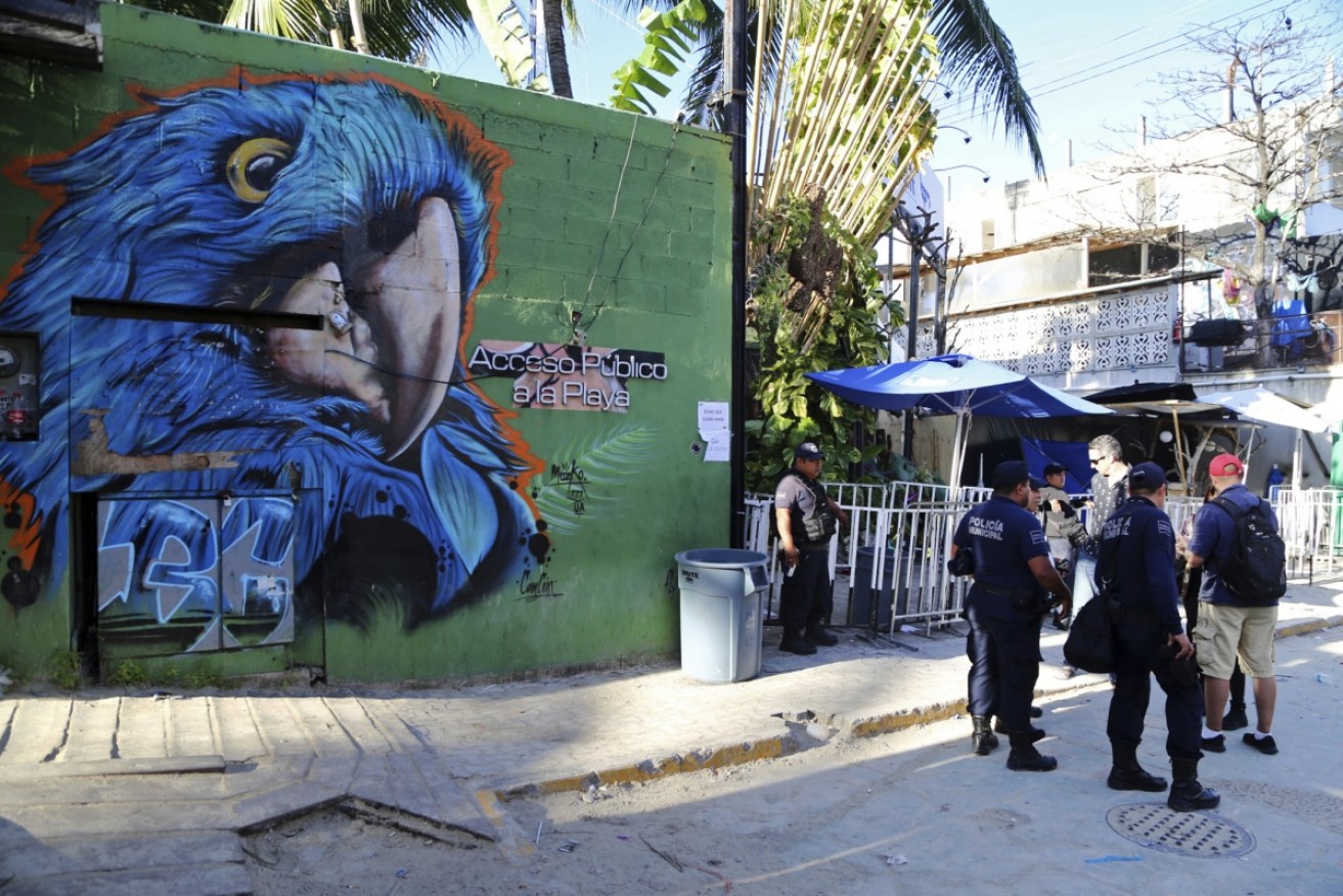 Police guard the entrance of the Blue Parrot nightclub in Playa del Carmen after the deadly shooting spree. 