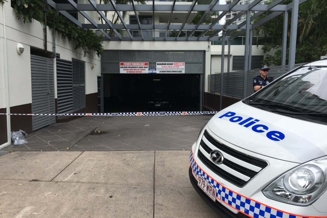 A police officer and a man are in hospital following a shooting in a Gold Coast apartment basement on early Sunday morning