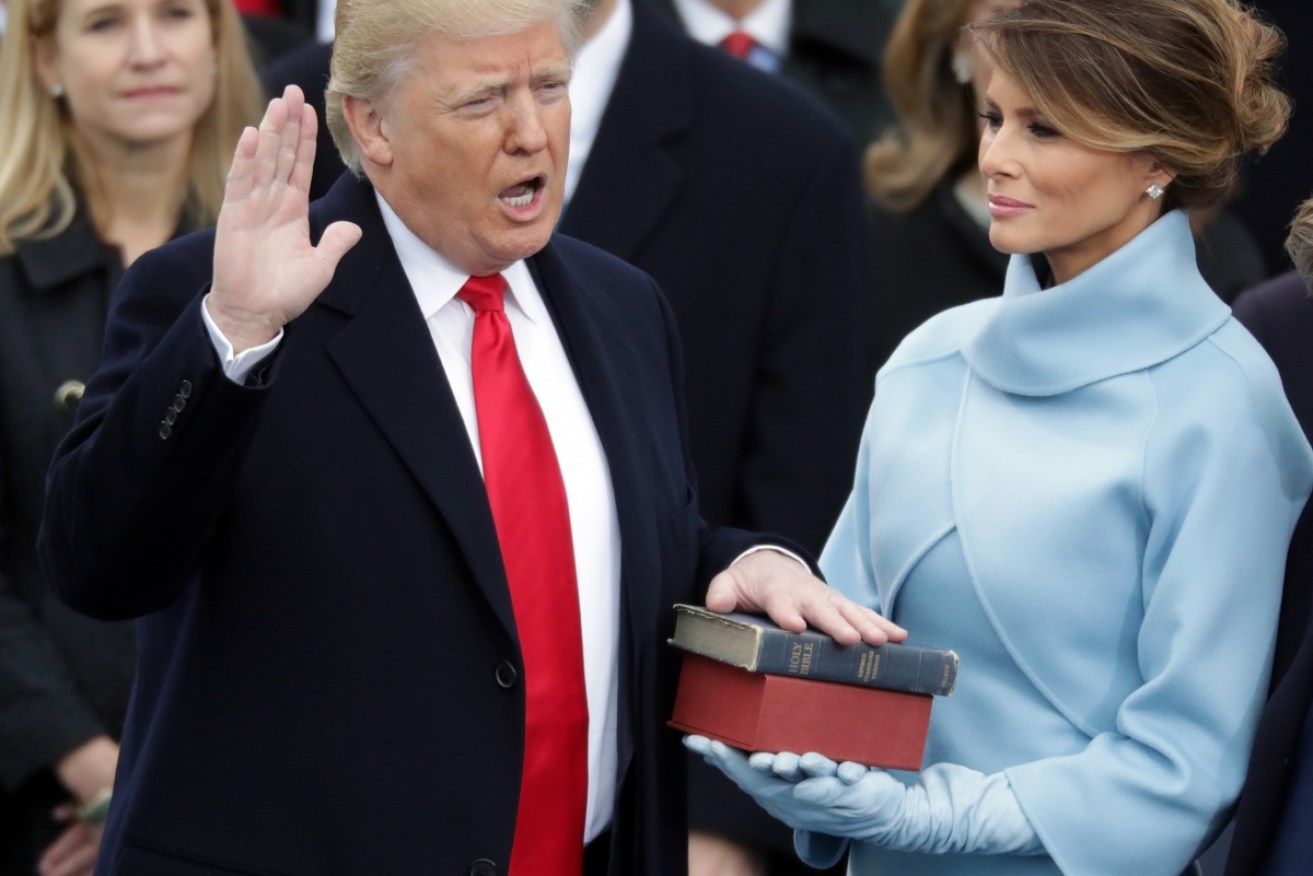 Melania Trump holds the Bible on the West Front of the US Capitol as her husband takes the oath of office. 