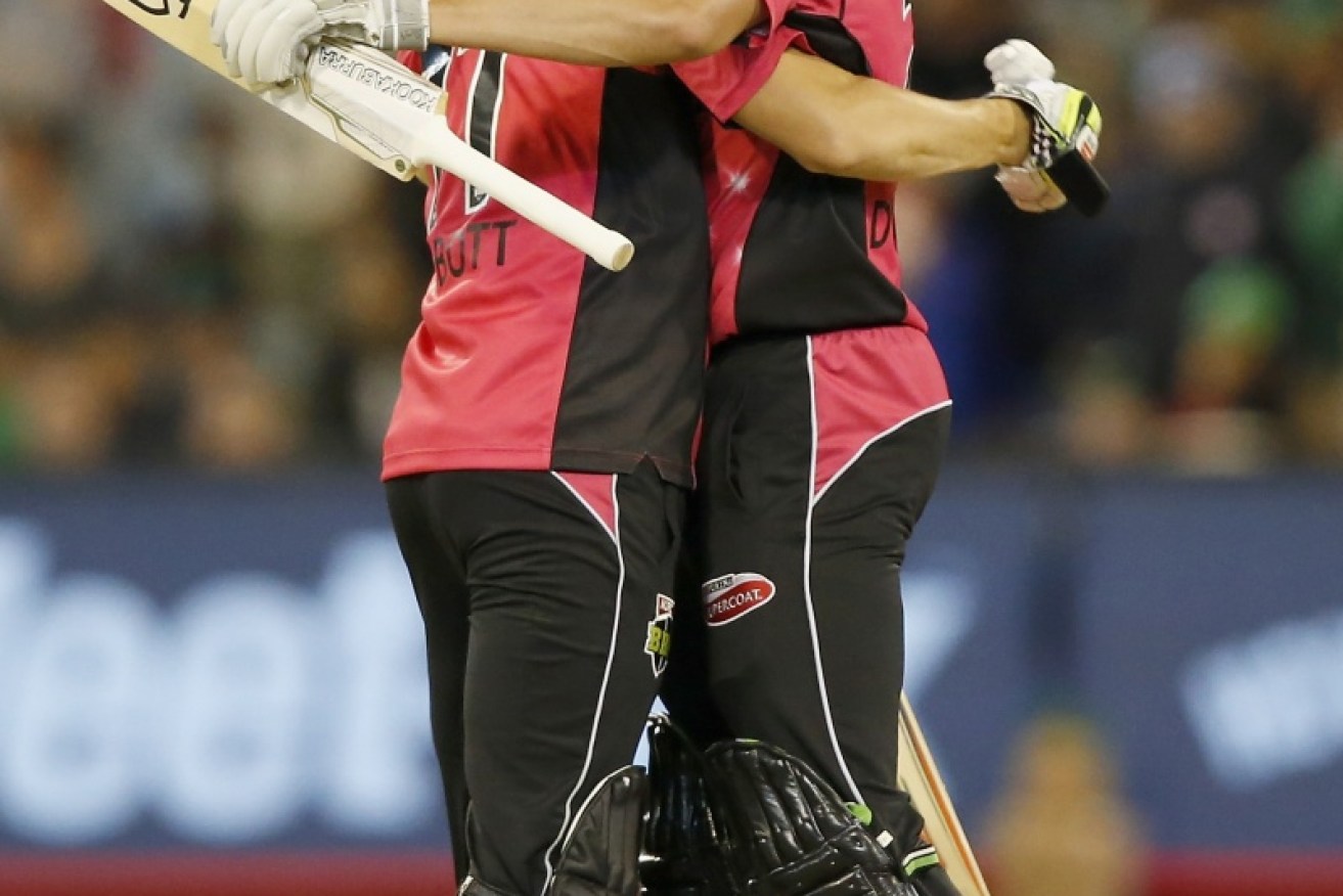 Ben Dwarshuis and Sean Abbott celebrate steering the Sydney Sixers to victory and a semi-final berth.