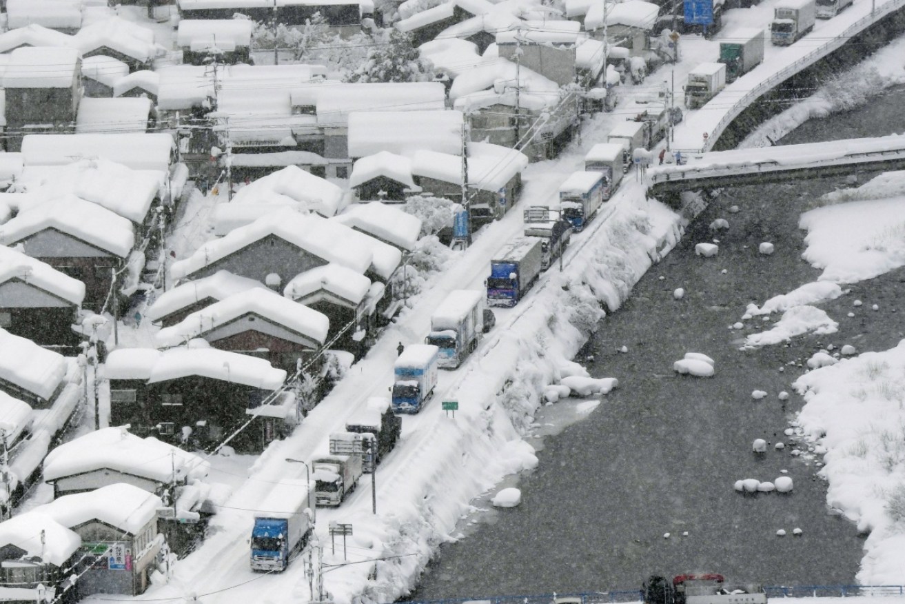 Hundreds of cars are stranded due to heavy snow on a road in western Japan.