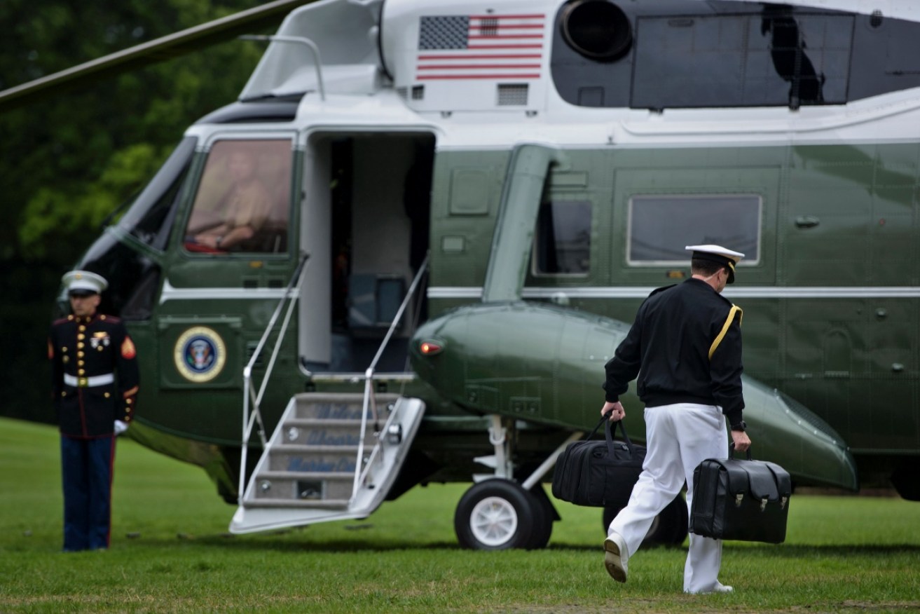 A soldier and the nuclear "football" stay close to the President at all times 