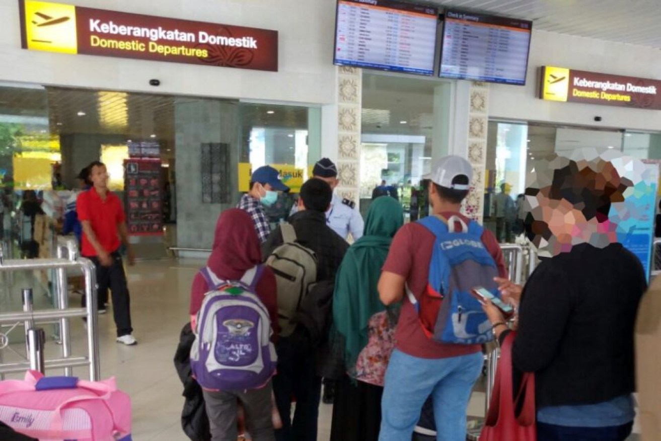 The family is escorted by anti-terror police to Jakarta.
