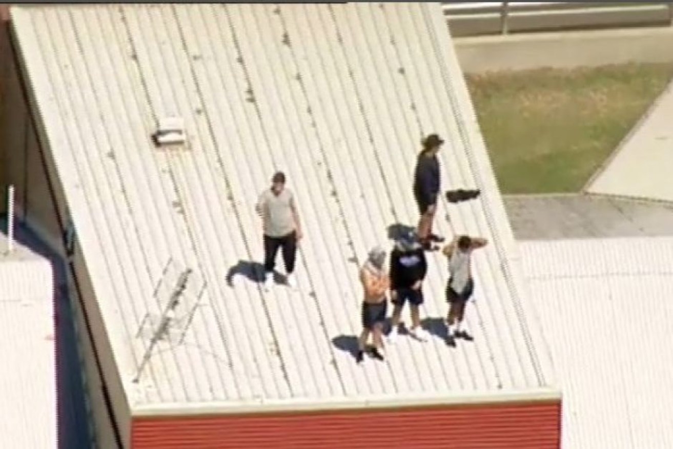 Youths on the roof of Malmsbury Youth Justice Centre.