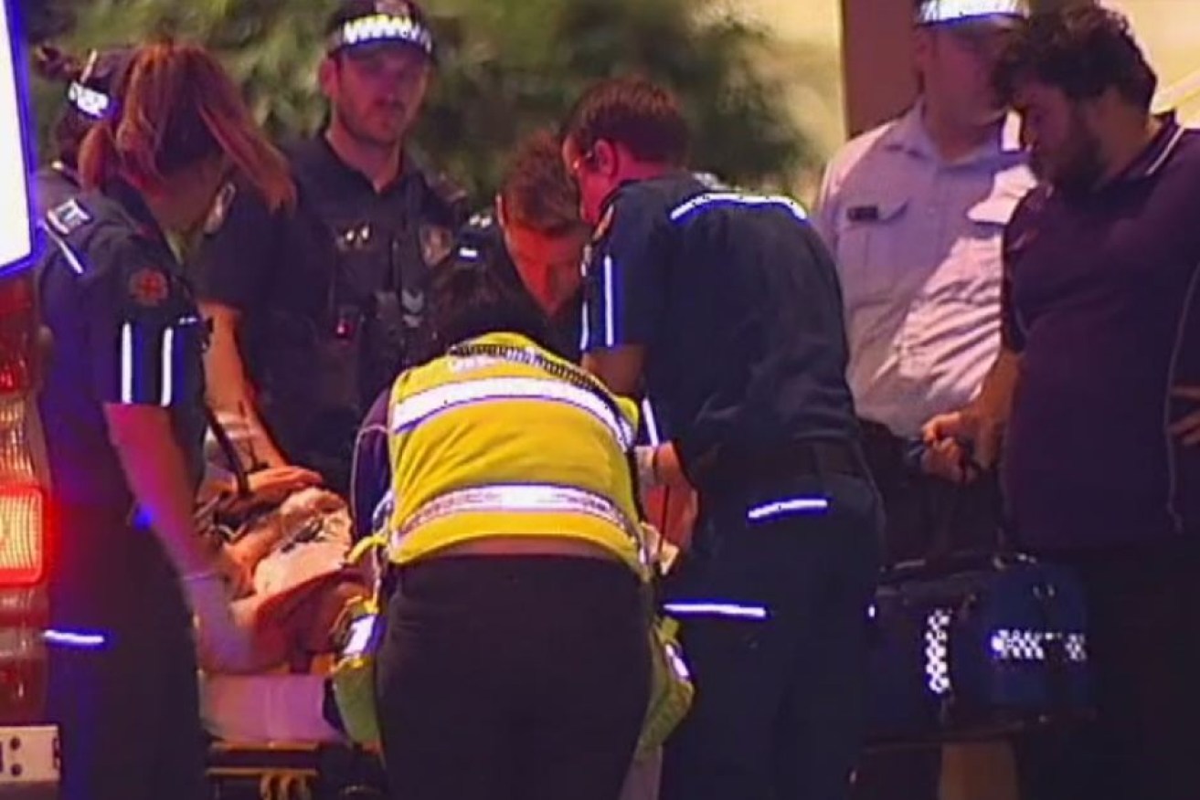 A victim of an alleged one-punch attack is treated by paramedics in Brisbane's Fortitude Valley. 