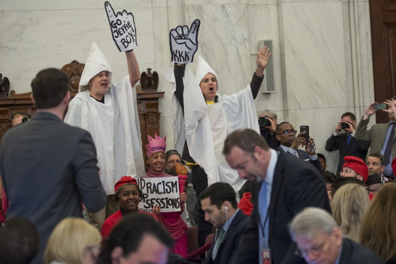 Demonstrators dressed as KKK members protested Jeff Sessions's hearing on Capitol Hill. 