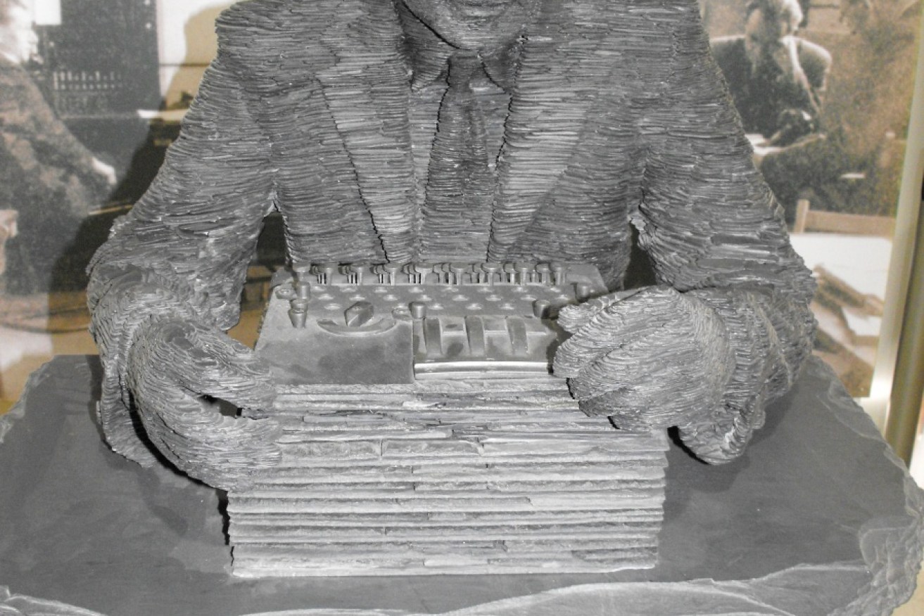 A slate statue of codebreaker and computing genius Alan Turning at Bletchley Park in England. 