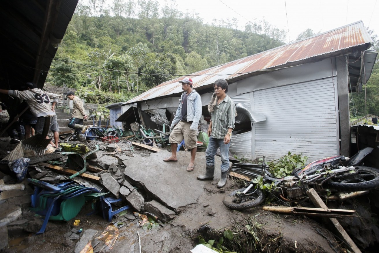 Villagers survey the damage after a landslide in Bangli, Bali. 