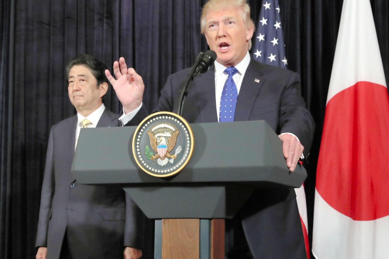 President Trump's public display of presidential activity during Japanese Prime Minister Shinzo Abe's visit has been labelled 'sloppy'.