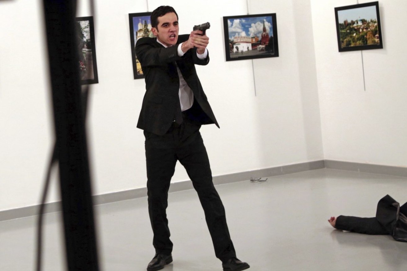 Mevlut Mert Altintas shouts after shooting Andrei Karlov, right, the Russian ambassador to Turkey, at an art gallery in Ankara, Turkey. 