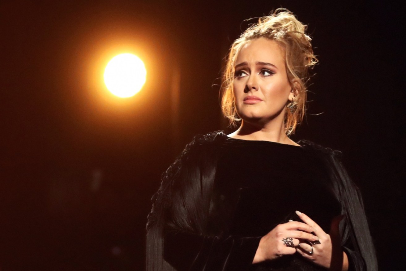 An emotional Adele restarted her tribute to George Michael live on air.