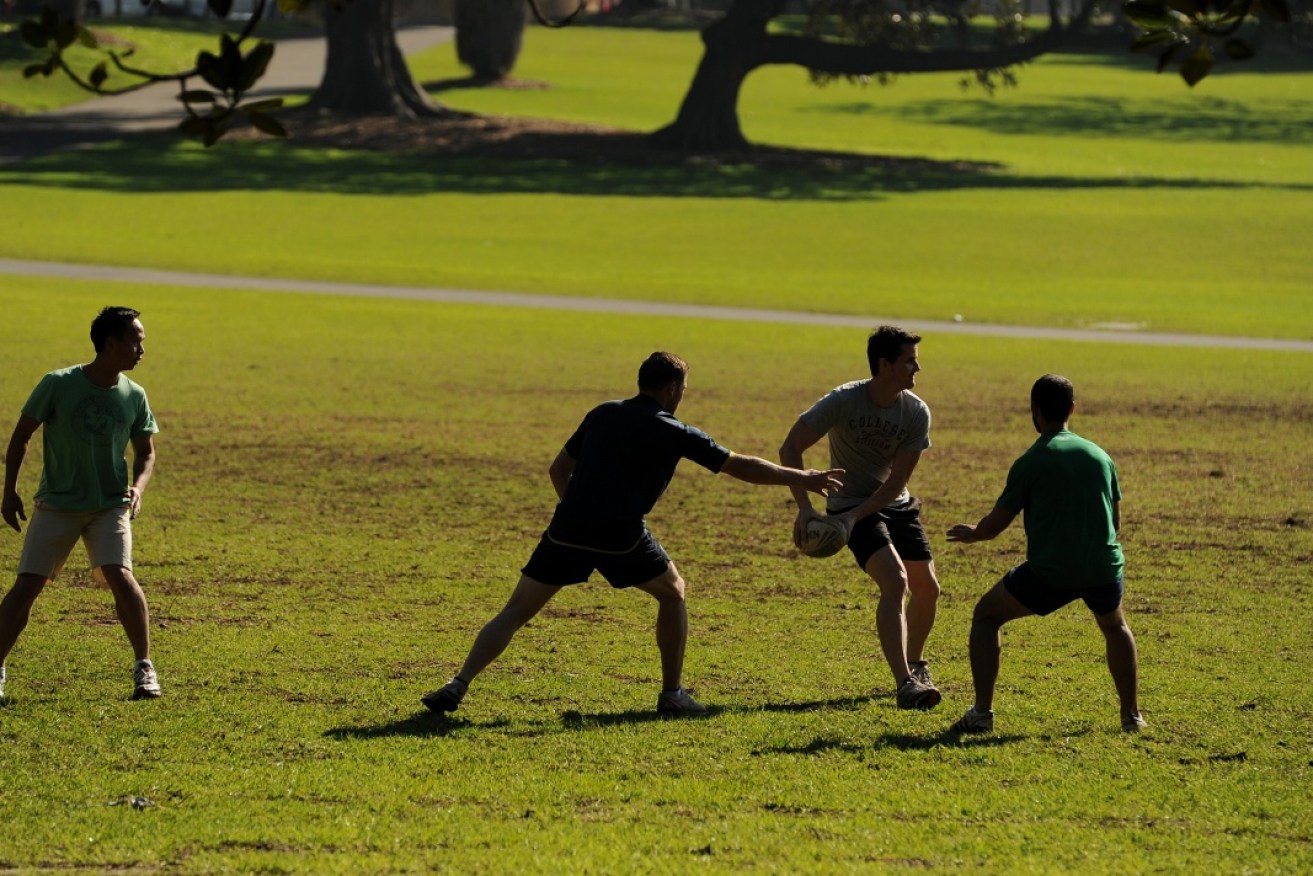 Young office workers playing touch football in Sydney – a new report says many are ready to walk out on their jobs. 