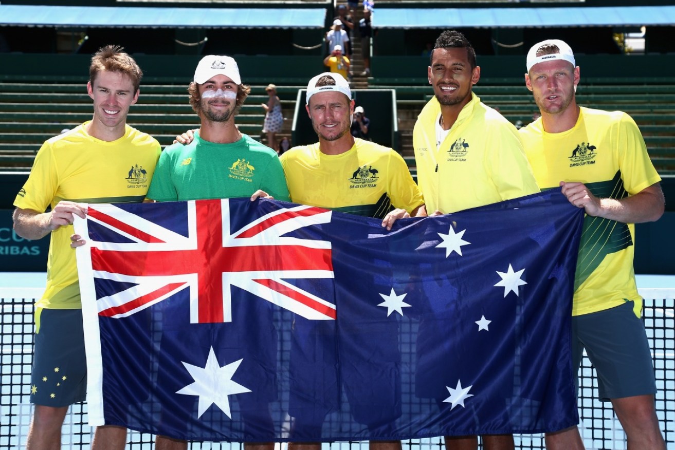 Australian captain Lleyton Hewitt celebrates with the team after Sam Groth and John Peers won their doubles match.