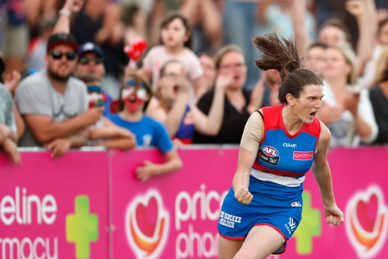 The fans love it as Bulldog Kirsten McLeod celebrates the first goal in the match against Fremantle.