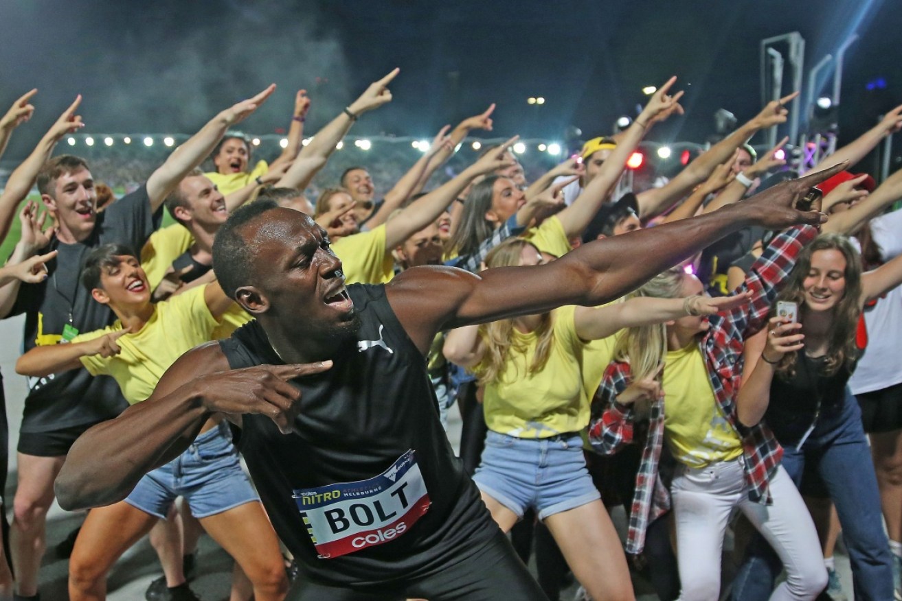 Usain Bolt unleashes his signature move for the crowd after winning the 150-metre sprint.