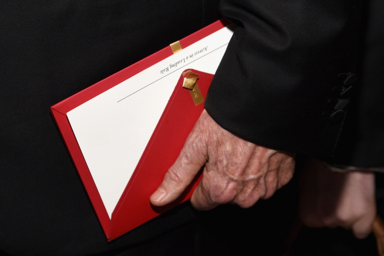 Presenter Warren Beatty holds the envelope containing the wrong award announcement for Best Picture at the Oscars.