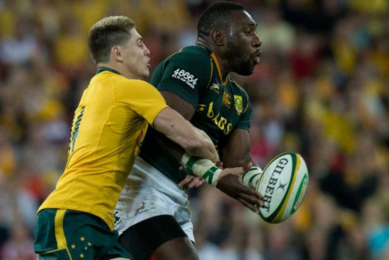Then-Wallaby James O'Connor (left) tackles South Africa's Tendai Mtawarira in 2013.
