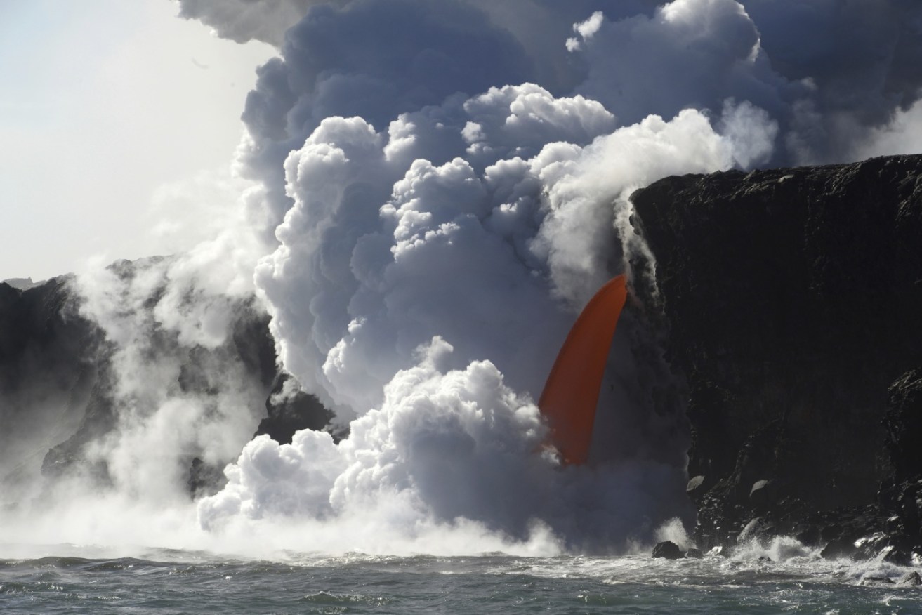 A "firehose" lava stream from Kilauea Volcano shoots out from a sea cliff on Hawaii's Big Island.