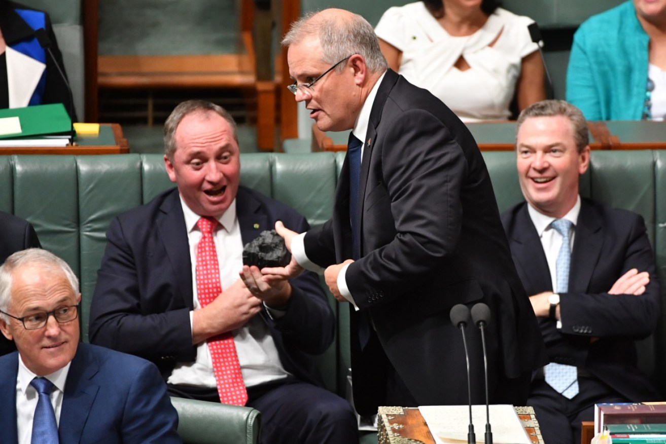 Scott Morrison brandishes a lump of coal in parliament. 