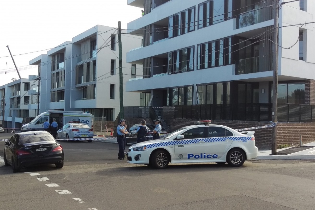 Detectives tape off the scene of a fatal shooting in Mortlake, in Sydney's inner-west, on Friday.