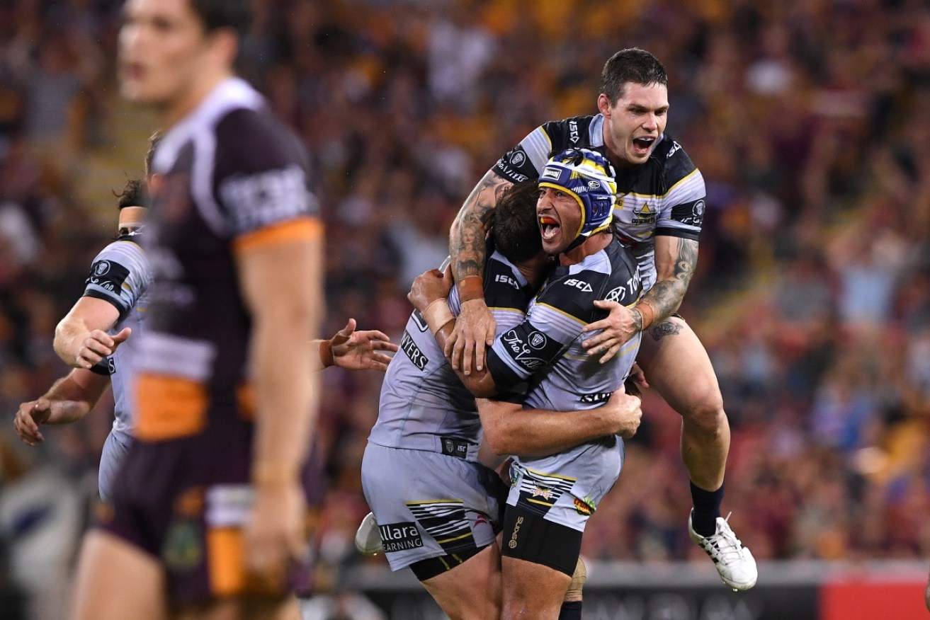 Johnathan Thurston and teammates react after he kicked the match-winning field goal against Brisbane.