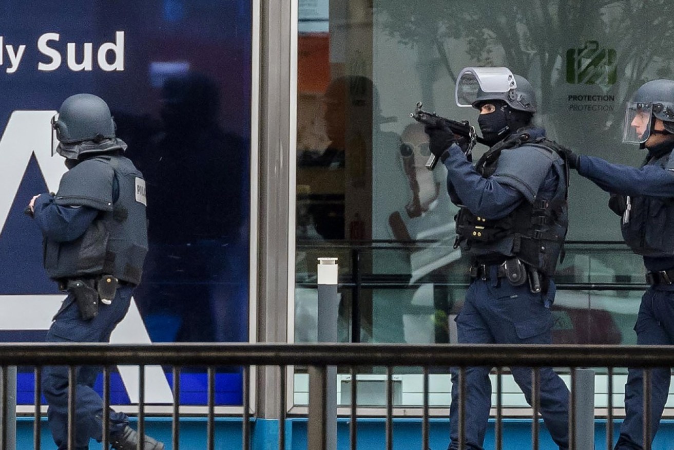 Special armed police units move into position at Orly airport, near Paris.