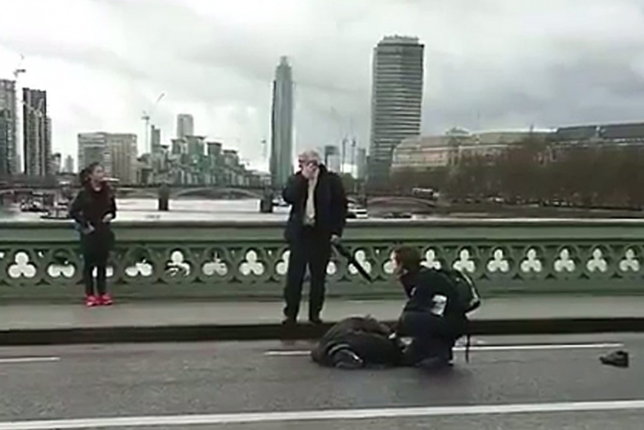 People rush to help a victim on Westminster Bridge after the attack taken by former Polish foreign minister Radoslav Sikorski.