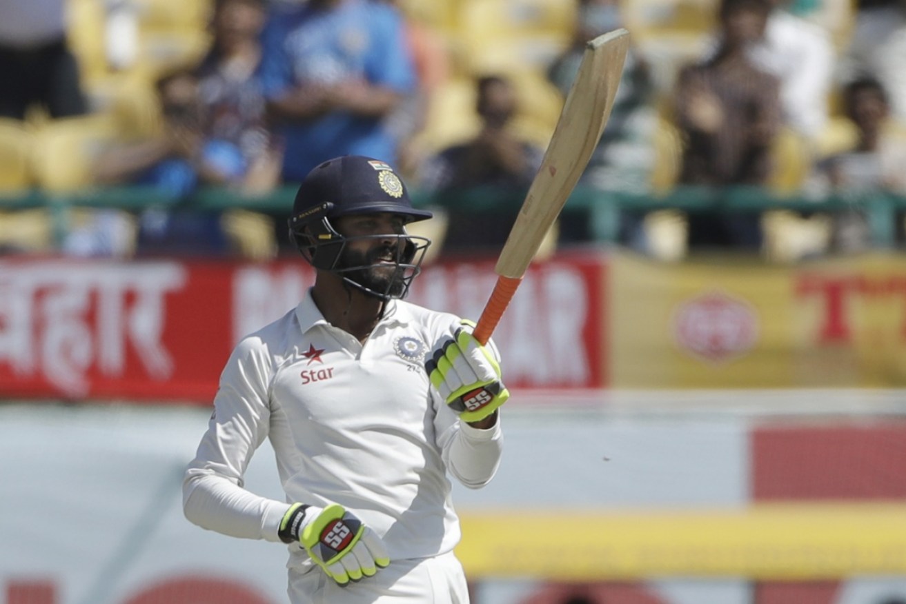 India's Ravindra Jadeja raises his bat after scoring fifty runs to turn the tide.