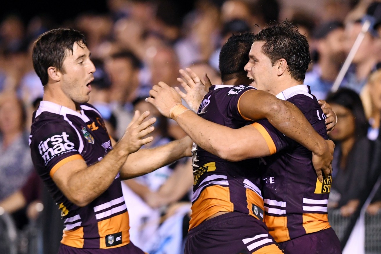 James Roberts (R) is congratulated by Ben Hunt (L) and Anthony Milford after scoring a try against the Sharks.