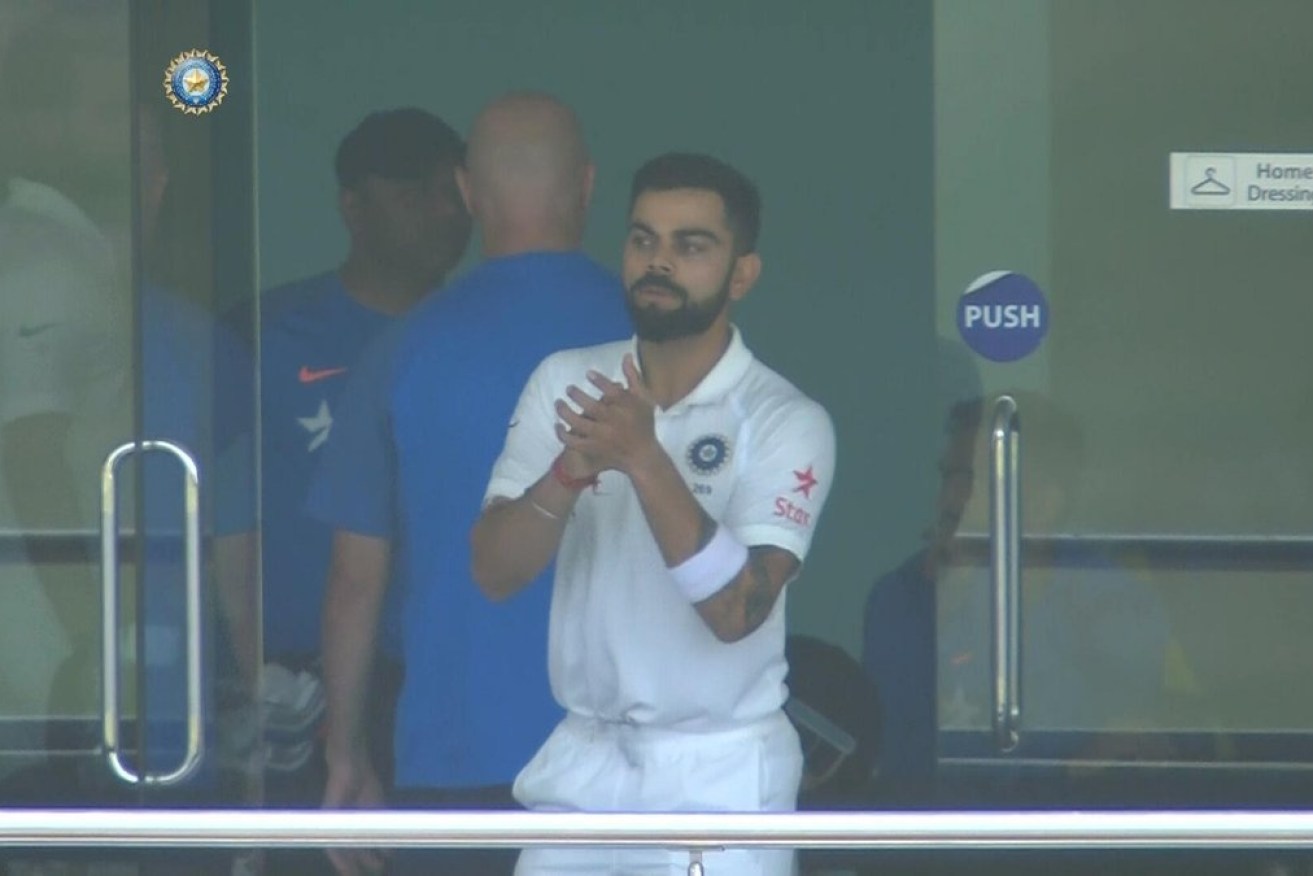 India captain Virat Kohl mocking applauds after Australia used up its video reviews.