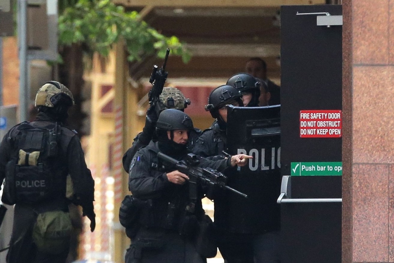 Armed police attend a hostage situation at the Martin Place Lindt Cafe.
