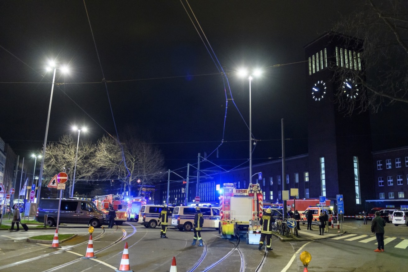 Police and emergency workers stand outside Dusseldorf station following an axe attack.