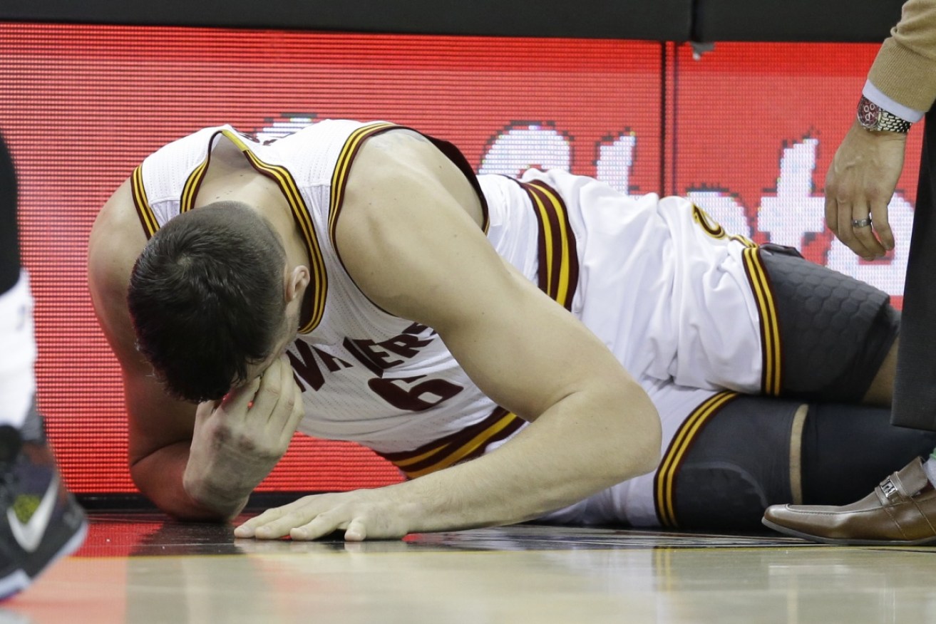 Bogut grabs his face in pain after his devastating injury. 