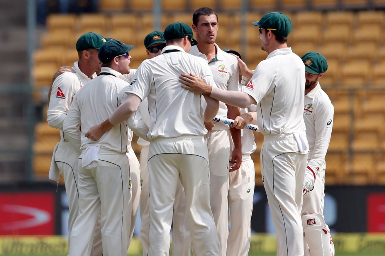 Australia celebrate a wicket in India.