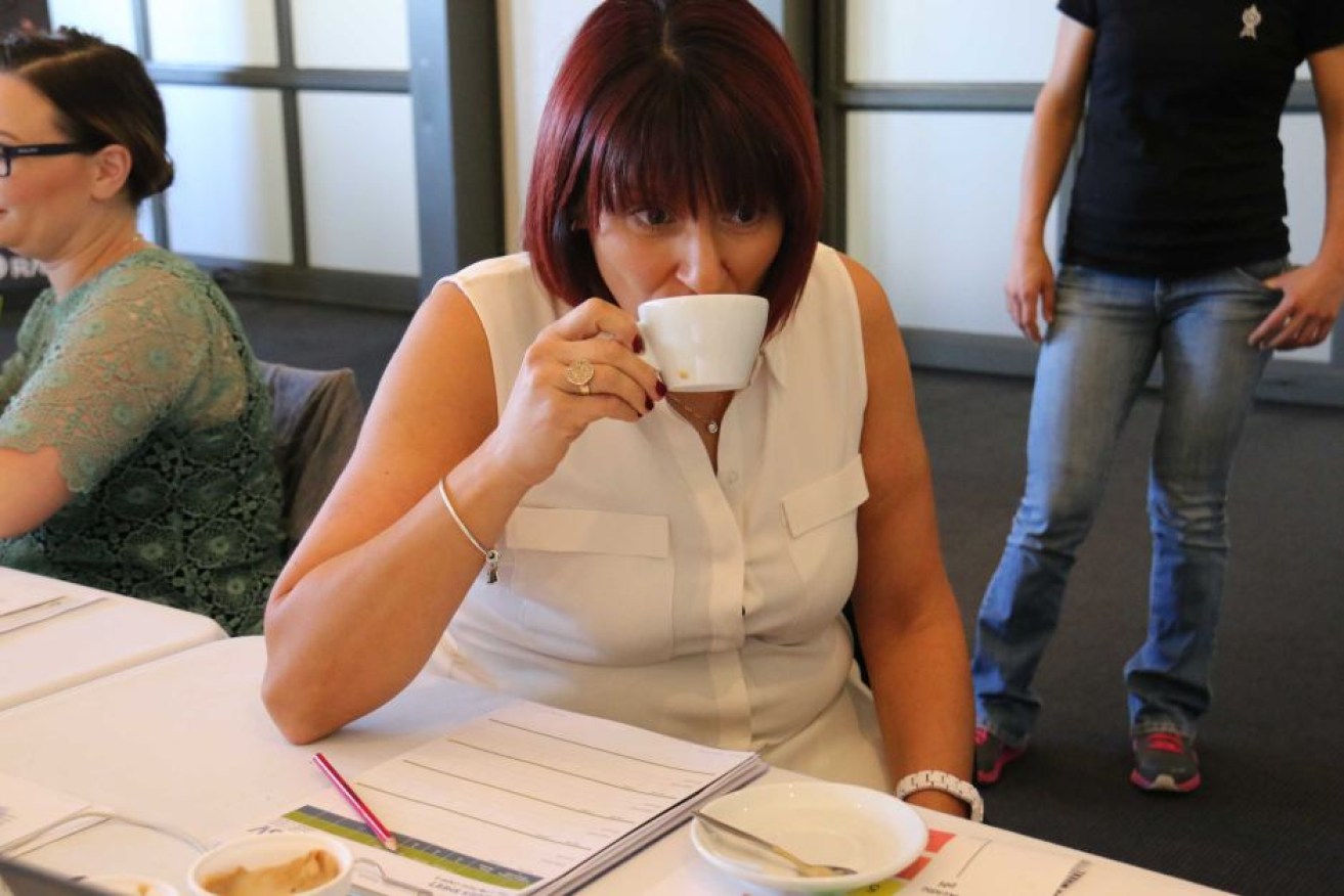 A woman drinking coffee at the 2017 Australian International Coffee Awards.