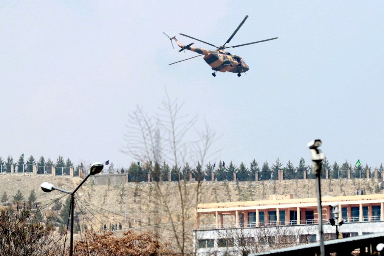 An Afghan military helicopter flies over the besieged hospital. 