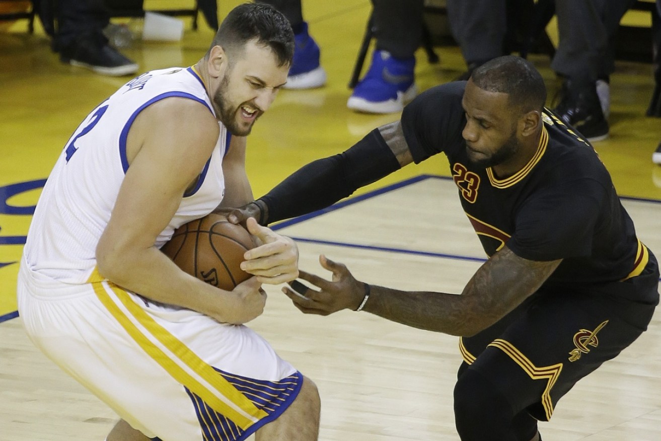 Andrew Bogut and Lebron James tussle in their days as rivals. 