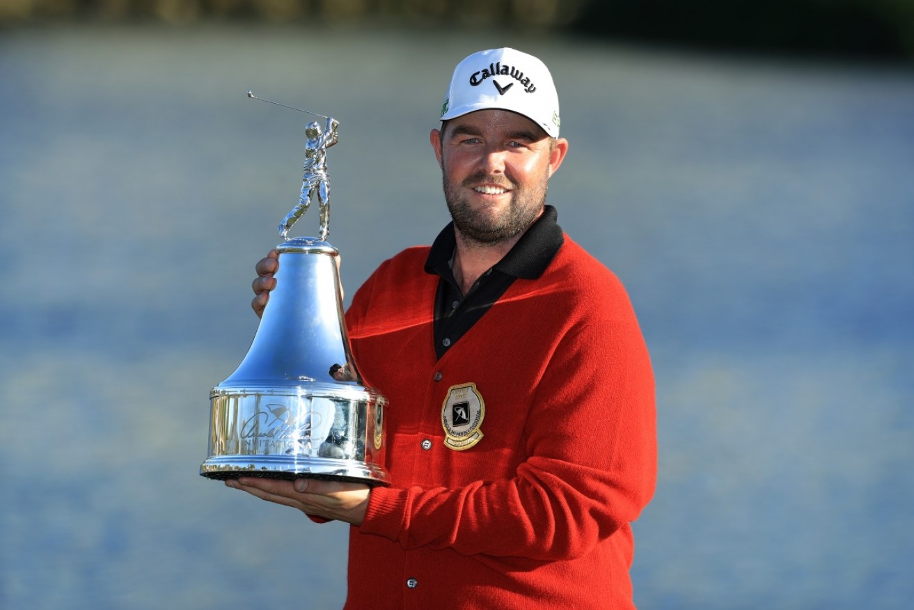 Marc Leishman poses with the trophy for his victory in Florida. 