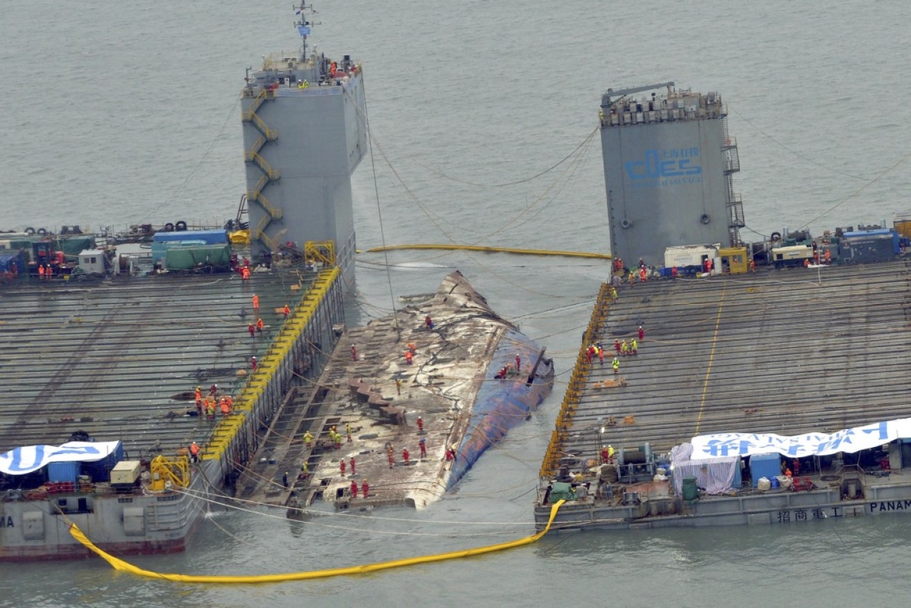 Workers prepare to lift the sunken Sewol ferry in waters off Jindo, South Korea.